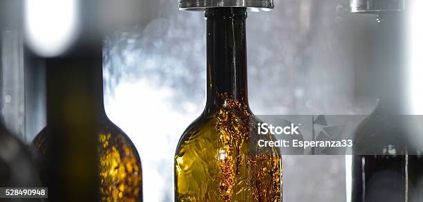 Wine Bottle Filling Along Conveyor Belt In Bottling Factory Stock Photo - Download Image Now
