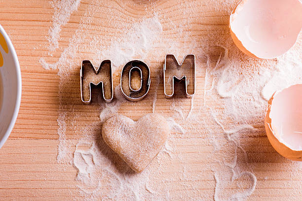 istock Mothers day composition. Cookie cutters. Wooden background. 528491370