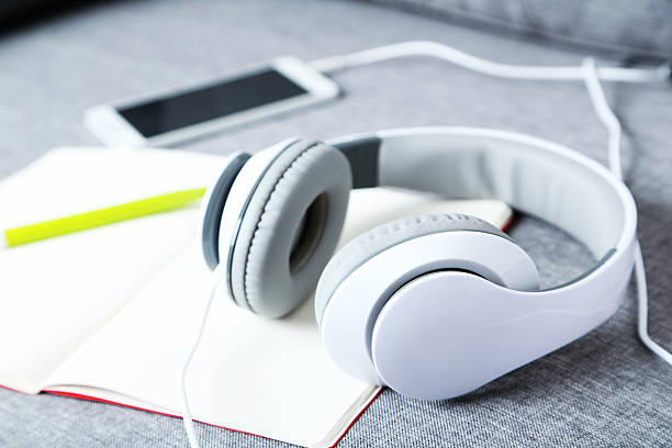 istock Headphones with smartphone on a grey sofa 528492332