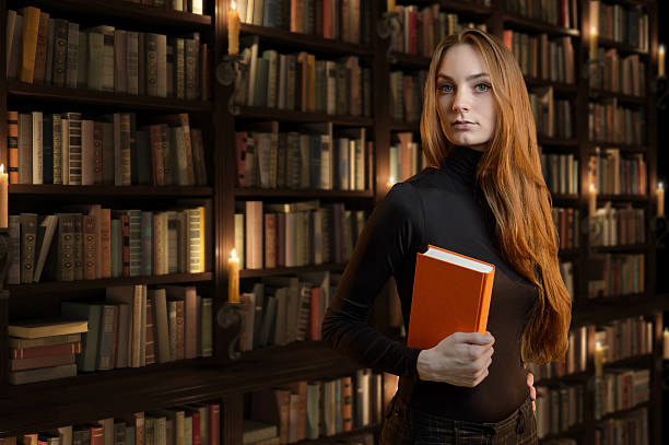istock Beautiful girl in the library / bookstore. 528493927