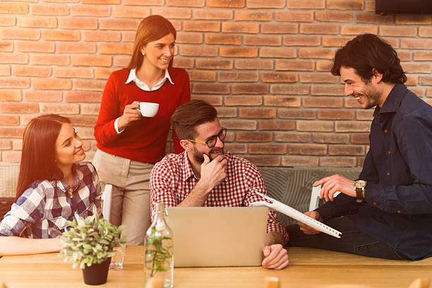 istock Four young casual business people came across original idea. 528494084