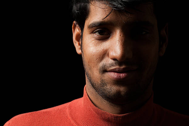 istock Portrait of young Indian man over dark 528494441
