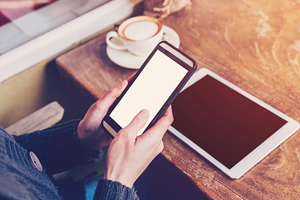 istock hand woman using smartphone in coffee shop 528494624