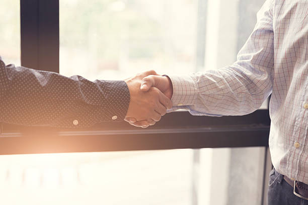 istock businessman handshaking for business acquisiton concept 528494810
