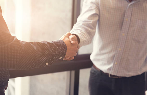 istock businessman handshaking for business acquisiton concept 528494856