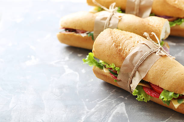 istock Tasty and fresh sandwiches on a grey table 528495136