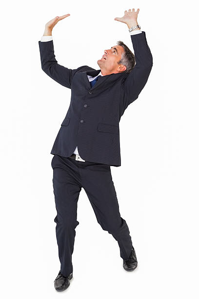 istock Businessman well dressed looking up and pushing 528495501
