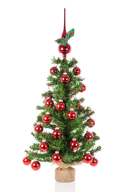 istock Decorated Christmas tree with peak balls over a white background 528495973