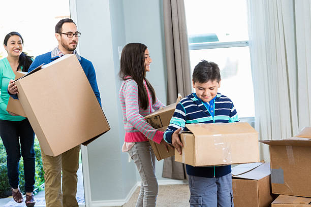 istock Family moves boxes into new home 528497178