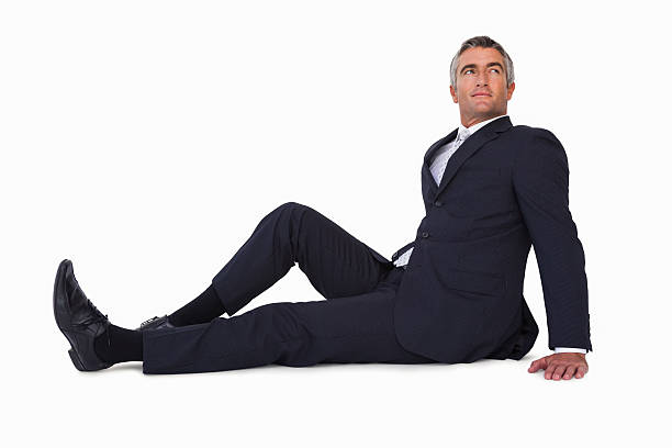 istock Smiling businessman sitting on the floor 528497187