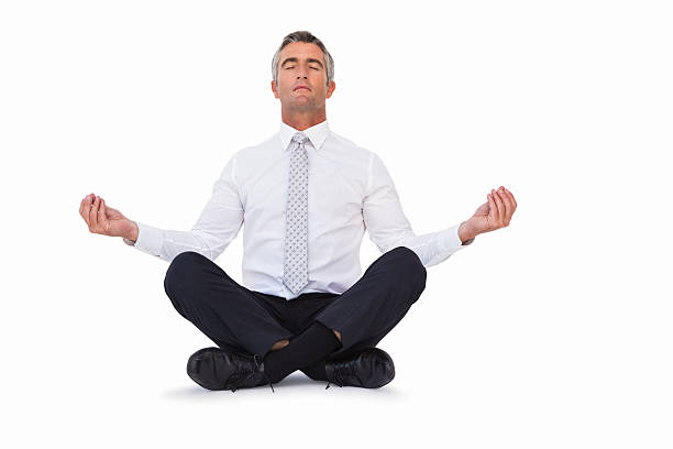 Peaceful businessman sitting in lotus pose