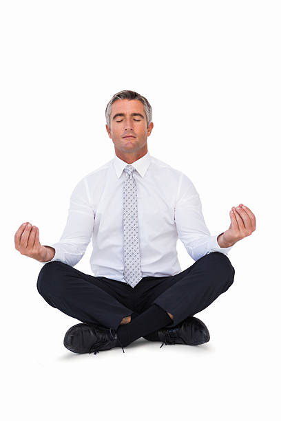 istock Zen businessman meditating in lotus pose 528497193