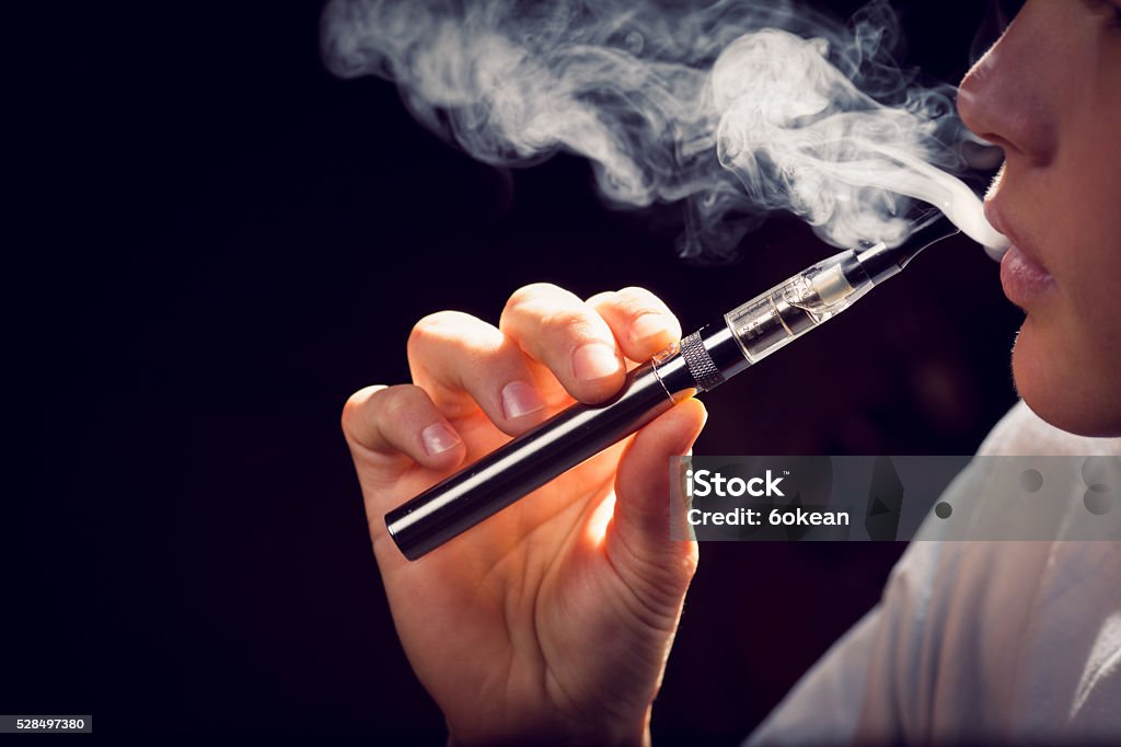 inhaling from an electronic cigarette. - Royalty-free Elektronik sigara Stok görsel