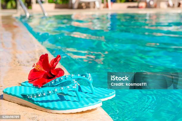Turquoise Flip Flops And Flower On The Edge Of Pool Stock Photo - Download Image Now