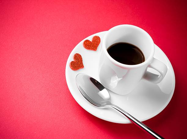 istock decorative red hearts near cup of coffee on red table 528499732