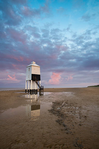 istock Beautiful landscape sunrise stilt lighthouse on beach 528500657