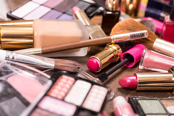 istock Pile of various cosmetics, make-up lie on wooden dressing table. 528500800