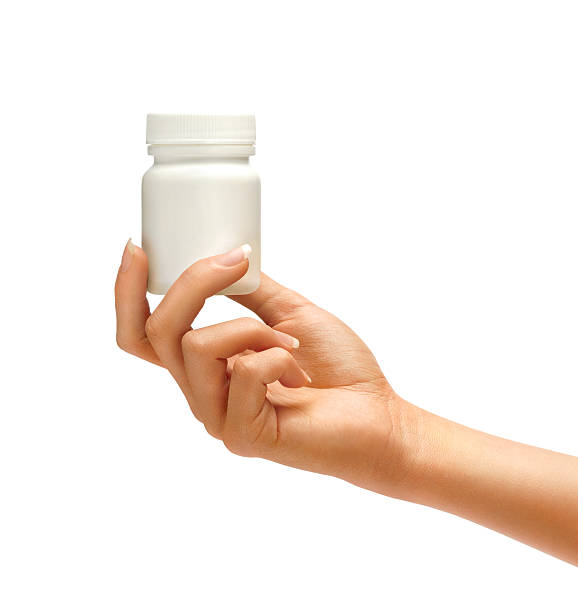 istock Female Hand is giving bottle for pills 528501284