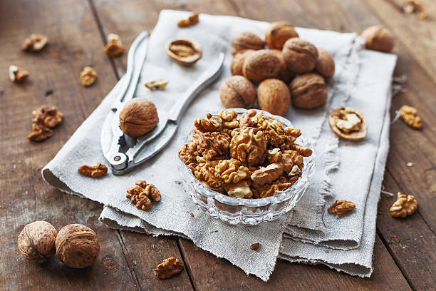 istock Glass bowl with walnuts on rustic homespun napkin. Healthy snack. 528501536