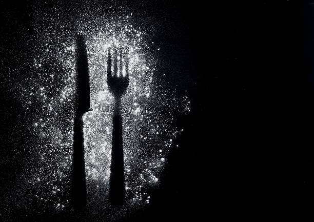 istock Imprint fork and knife made of flour on a black 528502852