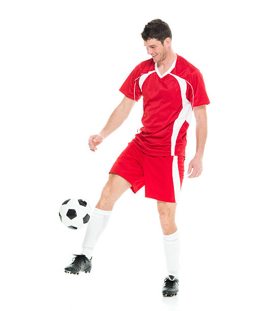 istock Smiling soccer player playing with ball 528503814