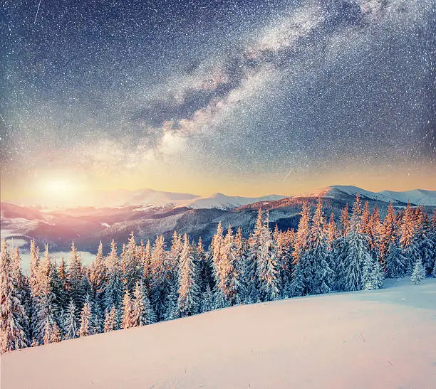 Photo of starry sky in winter snowy night. Carpathians, Ukraine, Europe