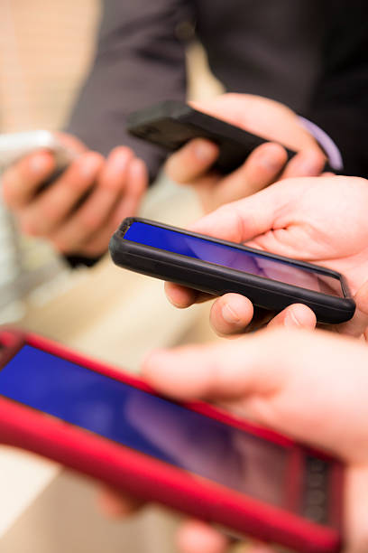istock Business people:  Professionals on cell phones by office window. 528504420
