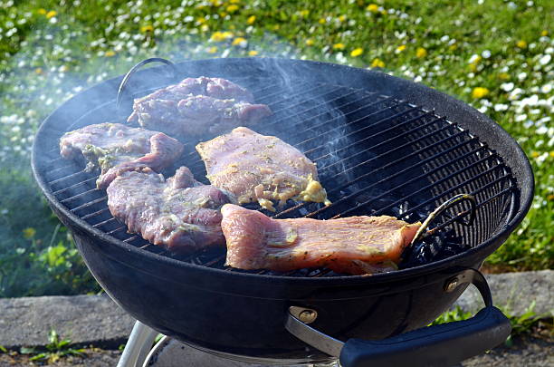 istock barbeque grill with fresh meat in evening sun 528504684
