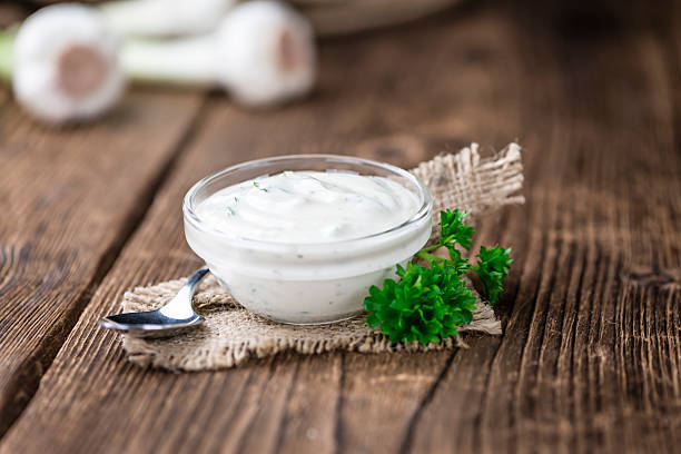 Homemade Garlic Sauce (detailed close-up shot) on wooden background