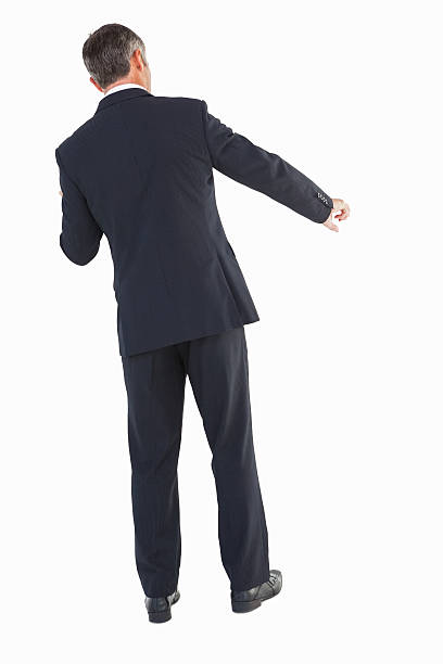 istock Businessman in suit standing and doing gesture 528530493