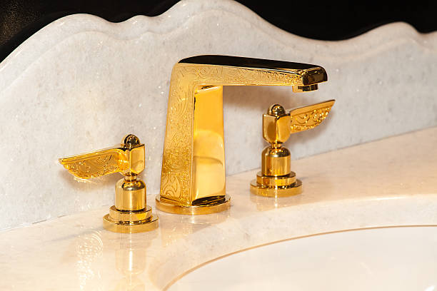 istock Gold faucet in bathroom 528556280