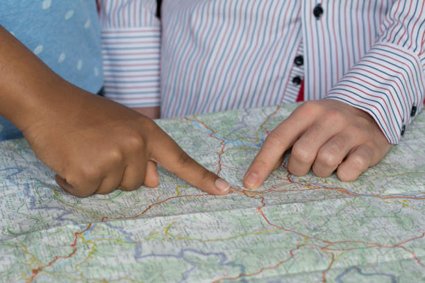 istock friends choosing tourist destination on a map 528557278