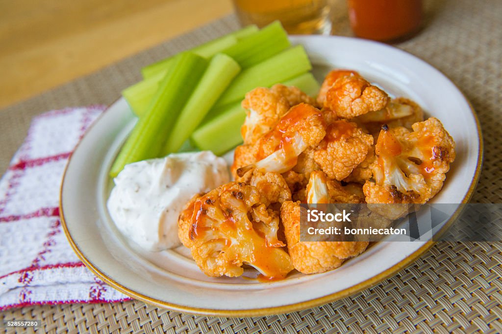 Buffalo Cauliflower Bites Spicy Buffalo cauliflower bites with dip and celerySpicy Buffalo cauliflower bites with dip and celery Cauliflower Stock Photo