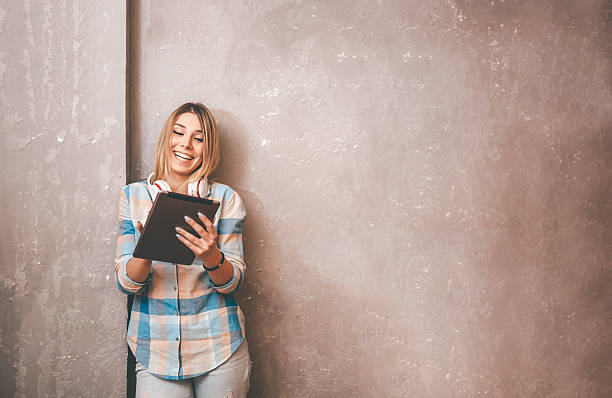 istock happy smiling young woman with digital tablet 528559692
