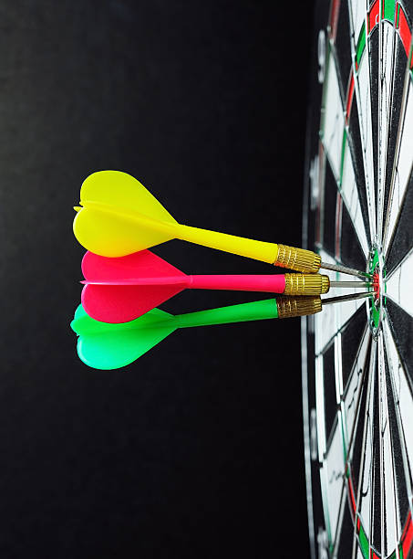 istock Darts on bulls eye with black background 528560246