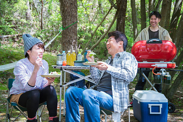 istock Three friends laughing together whilst enjoying a BBQ 528561954