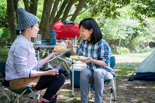 istock Two friends eating outdoors and laughing whilst sharing food 528561994