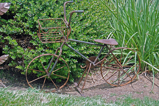 Metal sculpture of a bicycle in a garden in a winery in Northern California, Amador County, southeast of Sacramento.