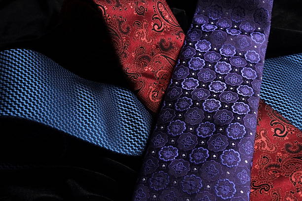 istock Three silk ties crossing on black velvet 528562345