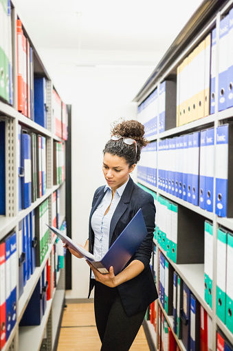 Secretary working in paper archive