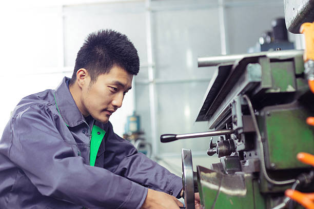 istock mechanic worker busy working on machine in factory 528562845