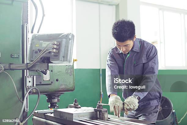 Mechanic Worker Busy Working On Machine In Factory Stock Photo - Download Image Now - Adult, Adults Only, Asian and Indian Ethnicities