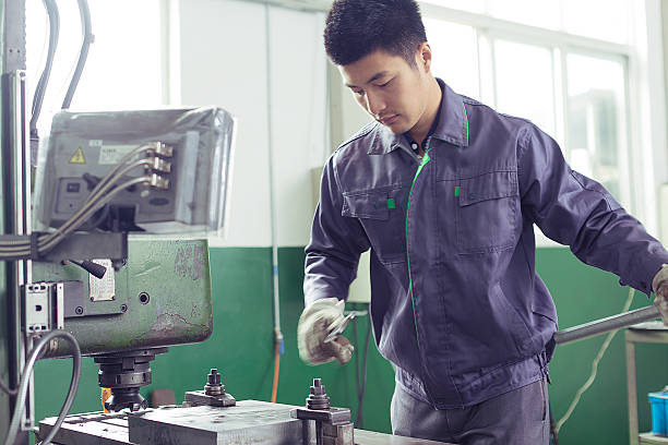 istock mechanic worker busy working on machine in factory 528562987