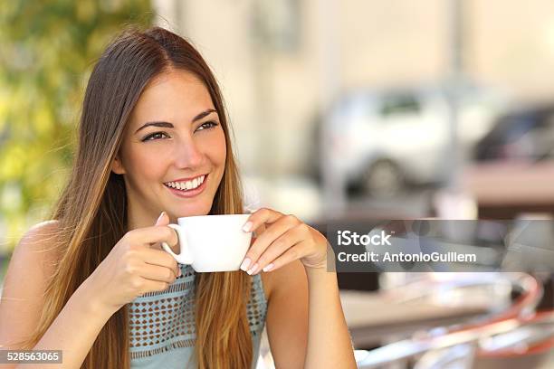 Pensive Woman Thinking In A Coffee Shop Terrace Stock Photo - Download Image Now - Coffee - Drink, Drinking, Tea - Hot Drink