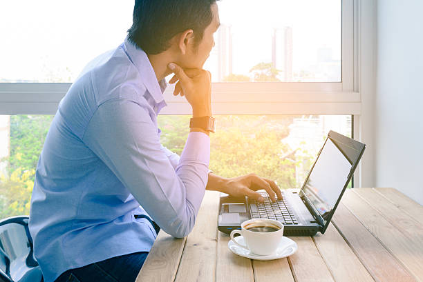 istock Businessman working with laptop and coffee by window. 528563250