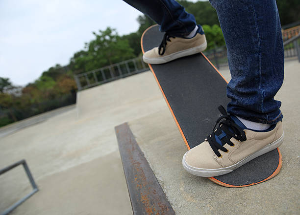 istock skateboarding legs at skatepark 528563990