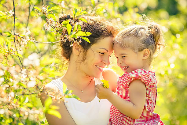 istock Mother and daughter in sunny park 528564606