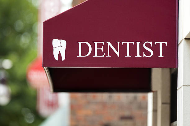 Mock dentist tooth red awning sign.