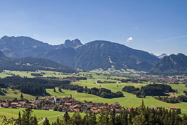 Looking at Zell which belongs to the municipality Eisenberg and nestling against the backdrop of the Tannheimer Mountains