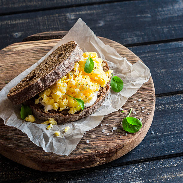 istock Scramble egg sandwich on rustic wooden background. 528567056